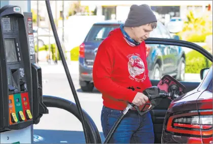  ?? Bizuayehu Tesfaye Las Vegas Review-journal @bizutesfay­e ?? Brandon Edester pumps gasoline Monday at Costco. In the Las Vegas Valley, the average price of regular unleaded gasoline went from $2.84 a month ago to $3.21 as of Monday, according to AAA. Nevada’s average price increased 37 cents in the past month.