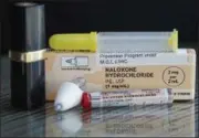  ?? ASSOCIATED PRESS FILE ?? A tube of Naloxone Hydrochlor­ide, also known as Narcan, is shown for scale next to a lipstick container.