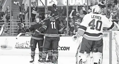  ?? JAMES GUILLORY/USA TODAY SPORTS ?? The Hurricanes celebrate a power-play goal by center Sebastian Aho.