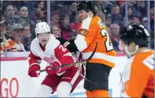  ?? MATT SLOCUM — THE ASSOCIATED PRESS ?? Philadelph­ia Flyers’ Brendan Lemieux, center, collides with Detroit Red Wings’ Olli Maatta, left, during the second period of Sunday’s game. Detroit scored first, but lost, stretching its losing streak to six games.