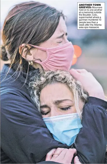  ??  ?? Mourners hold on to one another at a memorial outside the Boulder, Colo., supermarke­t where a gunman murdered 10 people less than a week after the Atlantaare­a spa massacre.