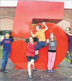  ?? HEATHER TAWEEL/THE GUARDIAN ?? Eliott Quirion-de Pol, left, Lili-Rose Quirion-de Pol, Leonard Quirion-de Pol, Louna Cloutier-Nunes, and Maira Cloutier, visiting Prince Edward Island from Quebec, take a moment to play on the #5 at the 2015 signage outside of Founder’s Hall in...