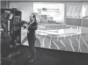  ??  ?? IQor Director of Technology David Travis demonstrat­es some of the cutting edge tech in IQor’s new Technology Room, including augmented reality and a man sized robot. The global provider of repairs, tech support and product testing for Internet-enabled technology devices celebrated an expansion of its southeast Memphis facility Wednesday. JIM WEBER/THE COMMERCIAL APPEAL