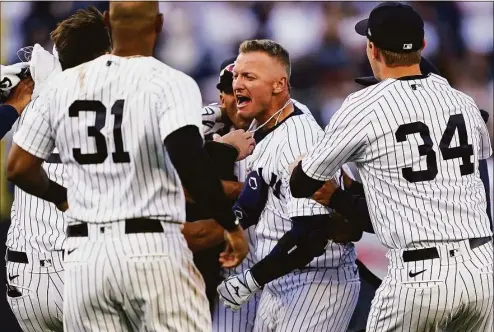  ?? John Minchillo / Associated Press ?? The Yankees’ Josh Donaldson, center, celebrates after hitting a walk-off single in the 11th inning against the Red Sox on Friday.