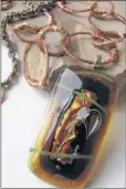  ??  ?? Art2wear will include one- of-a-kind pendant necklaces designed and created by artist Lisa Butts of Germantown who works with fired glass and hammered metal. Butts said she favors autumn colors.