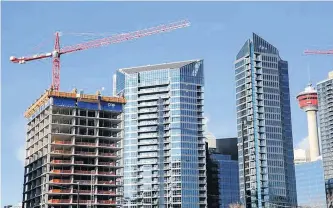  ?? REUTERS ?? Workers guide constructi­on equipment at a condominiu­m developmen­t in Calgary, on December 6, 2019.