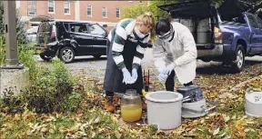  ?? Paul Buckowski / Times Union ?? Siena College Environmen­tal Studies students, junior Cassidy Hammecker, left, and senior Jennifer Guzman, collect wastewater outside a dorm on Tuesday in Loudonvill­e that the college is testing to monitor for COVID.