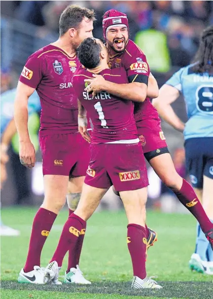  ?? Picture / AAP ?? Queensland playmaker Johnathan Thurston celebrates beating NSW in the arms of fullback Billy Slater. Thurston believes he will be ready to play in the Origin decider despite a serious shoulder injury.