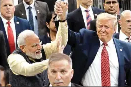  ?? AP ?? President Donald Trump and Indian Prime Minister Narendra Modi walk around NRG Stadium waving to the crowd during the "Howdy Modi: Shared Dreams, Bright Futures" event, Sunday