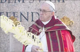  ?? ANDREW MEDICHINI — THE ASSOCIATED PRESS ?? Pope Francis celebrates a Palm Sunday Mass in St. Peter’s Square at the Vatican on Sunday.