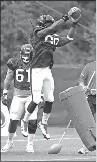  ?? Associated Press ?? Keep your eye on the ball: Houston Texans defensive end Jadeveon Clowney (90) leaps up to catch a football during training camp last month in White Sulphur Springs, W.Va.