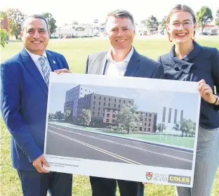  ?? JIM DAY/THE GUARDIAN ?? Premier Dennis King, middle, and UPEI president Alaa Abd-El Aziz are joined by UPEI student union president Emma Drake in displaying an artist’s conceptual drawing of a 260-bed residence building that is expected to be completed on campus by 2022.