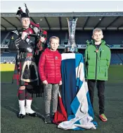  ??  ?? Two nations: the Auld Alliance Trophy at Murrayfiel­d ahead of the Six Nations match between Scotland and France tomorrow with, from left, bagpiper Ryan Steele, Romain Cabanas, a descendant of Burgun, and Lachlan Ross, a descendant of Milroy