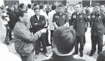  ??  ?? COMMAND CONFERENCE – President Duterte talks with officials of the Security Cluster on the sidelines of the AFP-PNP Command Conference at the Arcadia Active Lifestyle Center in Davao City Thursday. (Malacanang photo)