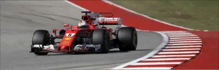  ?? ASSOCIATED PRESS FILE PHOTO ?? Ferrari driver Sebastian Vettel of Germany comes through a turn during the U.S. Grand Prix at the Circuit of the Americas last Sunday.