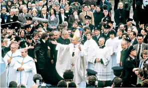  ??  ?? Changing times: Pope John Paul II in 1979, the first trip to Ireland by a pope. Below, a souvenir ‘lollipope’ for Pope Francis’s visit to Dublin this weekend