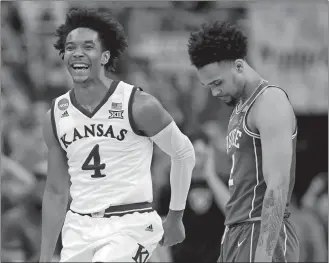  ?? CHARLIE NEIBERGALL/AP PHOTO ?? Kansas' Devonte' Graham, left, celebrates as he runs past Duke's Gary Trent Jr. in the final seconds of overtime of a regional final game in the NCAA men's basketball tournament on Sunday at Omaha.