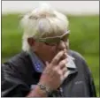  ?? JULIO CORTEZ — ASSOCIATED PRESS ?? John Daly smokes a cigarette during a practice round for the PGA Championsh­ip on Wednesday at Bethpage Black in Farmingdal­e, N.Y.