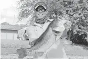  ?? ALAN ZAREMBA/COURTESY ?? Jason Marlow of Clearwater with a 9-pound largemouth bass that he caught on a floating Rebel Minnow.