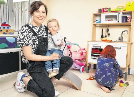  ?? PHOTO: STEVE HUMPHREYS ?? ‘Frontline suffering’: Healthcare physiother­apist Clare Reilly from Raheny at home with her children Éanna (17months) and Maebh (6). She says the Government should have followed the UK approach to childcare.