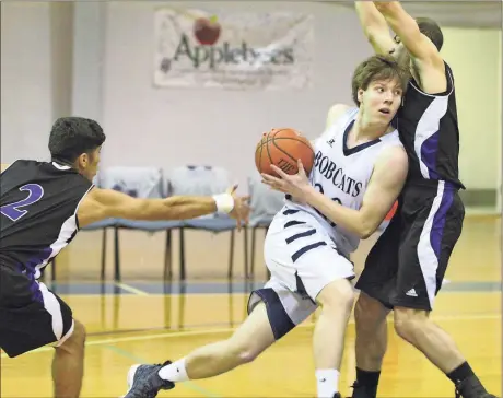  ??  ?? Tyler Phillips make contact with a Crown College defender while driving to the hoop. The Bobcats cruised to a big win, 88-65, this past Monday. (Photo by Scott Herpst)