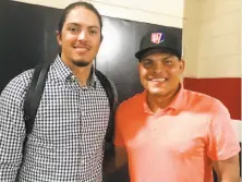  ?? John Shea / The Chronicle ?? Hall of Famer Ivan Rodriguez (right) poses with son Dereck after the younger Rodriguez made his second big-league start.