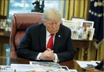  ?? EVAN VUCCI — THE ASSOCIATED PRESS ?? President Donald Trump looks at his notes during a briefing on Hurricane Dorian in the Oval Office of the White House, Wednesday in Washington.
