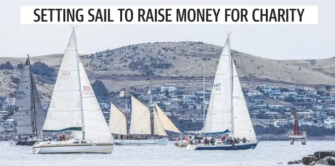  ??  ?? Some of the yachts and motor cruisers pass the John Gow Light at Sandy Bay during the Hobart Rotary Club Charity Sail Day on the River Derwent.
Picture Eddie Safarik