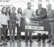  ??  ?? Winning team: Hemas Manufactur­ing (Pvt.) Ltd receives the award and prize from chief guest Lanka Hospitals PLC Group Chief Executive Officer Dr. Prasad Medawatte and SLIM President Pradeep Edward