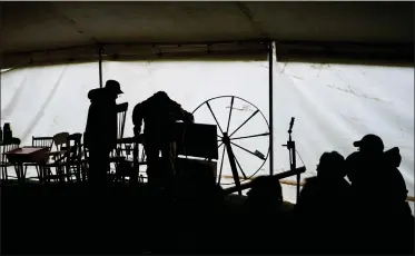  ?? AP PHOTOS BY MATT ROURKE ?? Attendees inspect antiques that were to be auctioned at Saturday’s mud sale.