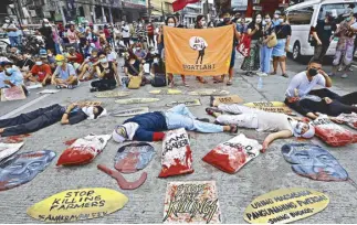  ?? EDD GUMBAN ?? Members of farmers’ groups stage a protest rally at the Chino Roces (formerly known as Mendiola) Bridge in Manila yesterday to commemorat­e the Mendiola massacre that left 13 farmers dead in 1987.