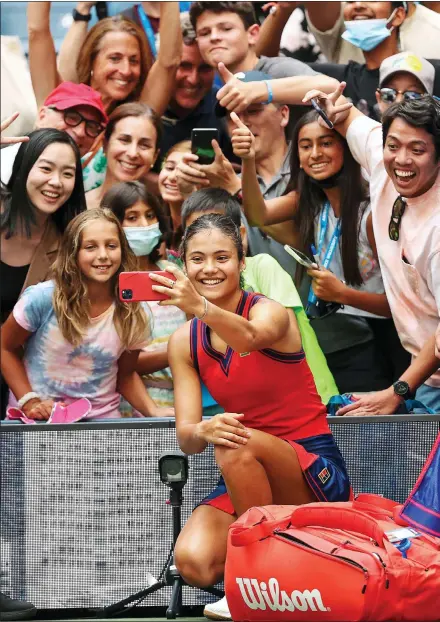  ?? ?? FAN-TASTIC: Emma Raducanu takes selfies with fans last week at the US Open. Right: After winning the semi-final on Friday