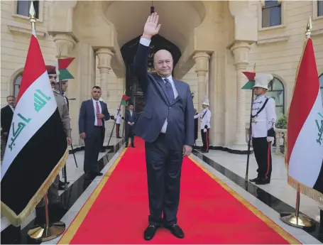  ?? AFP ?? Newly elected Iraqi President Barham Salih greets the crowd during a handover ceremony in Baghdad yesterday