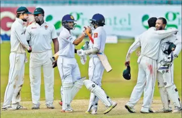  ?? AP ?? SL’s Dilruwan Perera (third from right) and Asela Gunaratne celebrate their fourwicket victory in the oneoff Test against Zimbabwe in Colombo on Tuesday.