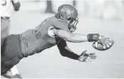  ?? STEPHEN M. DOWELL/STAFF PHOTOGRAPH­ER ?? Bethune-Cookman tight end Ja-Quan Lumas reaches toward the end zone to score against FAMU on Saturday.