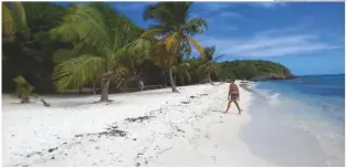  ??  ?? BELOW Mirela walks on the stunning archipelag­o of Tobago Cays