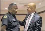  ?? REBECCA BREYER ?? Atlanta Police Department Officer C.J. Maddox Jr. (left) speaks with DeKalb County Sheriff Jeff Mann. Mann was fined $2,000 and ordered to perform 80 hours of community service.