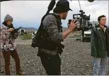  ?? SEARCHLIGH­T PICTURES/2020 20TH CENTURY STUDIOS/TNS ?? From left, director/writer Chloe Zhao, director of photograph­y Joshua James Richards and actor Frances McDormand on the set of “Nomadland.”