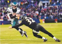  ??  ?? Philadelph­ia Eagles quarterbac­k Carson Wentz gets past Baltimore Ravens safety Eric Weddle for a touchdown Sunday. Gail Burton, The Associated Press