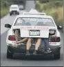  ??  ?? Migrants from the US-bound caravan take a lift in the boot of a taxi in Mexico.