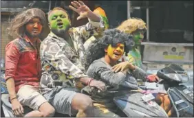  ??  ?? Young people, with their faces smeared with colored powder, ride on motor bikes during Holi festivitie­s in Hyderabad, India. (AP/Mahesh Kumar A.)