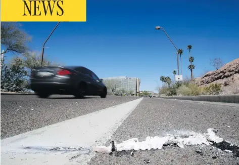  ?? CHRIS CARLSON / THE ASSOCIATED PRESS ?? Cars pass the scene in Tempe, Ariz., close to where a pedestrian was struck by an Uber vehicle Sunday night. The vehicle was in autonomous mode with an operator behind the wheel when the woman was hit. Uber suspended all of its self-driving testing Monday, including a program in Toronto.