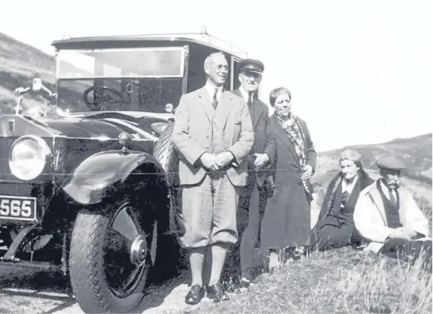  ??  ?? Some folk resting by a Rolls-Royce enjoying the view at the Cairn o’ Mount