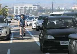  ?? Christian K. Lee Los Angeles Times ?? TOM KRENZKE, 35, uses a bike lane on Vista del Mar in Playa del Rey. Street parking will be eliminated so one traffic lane in each direction can be restored.