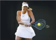  ?? Clive Brunskill / Getty Images ?? Maria Sharapova hits a return against Vitalia Diatchenko during Tuesday’s match at Wimbledon.