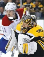  ?? Associated Press photo ?? Boston Bruins’ Anton Khudobin, right, deflects a shot off his mask in front of Montreal Canadiens' Brendan Gallagher (11) during the third period of an NHL hockey game in Boston, Saturday.