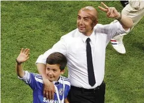  ?? — Reuters ?? Memorable outing: Chelsea manager Roberto di Matteo and his son waving to Chelsea supporters at the Allianz Arena in Munich on Saturday.