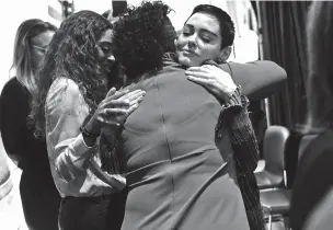  ??  ?? Rose McGowan embraces a supporter Oct. 27 before taking the stage to speak at the opening session of the Women’s Convention at the Cobo Center in Detroit. The actress has accused the producer Harvey Weinstein of raping her and has developed a massive following as a fiery feminist on Twitter.