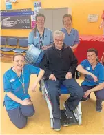  ??  ?? Ken Clark with Ninewells Hospital staff who helped nurse him back to health from the coronaviru­s.