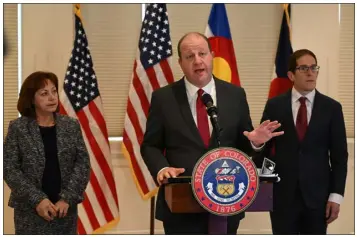  ?? HELEN H. RICHARDSON — THE DENVER POST ?? Colorado Gov. Jared Polis, with Lieutenant Governor Dianne Primavera, left, and Mark Ferrandino, the state’s budget director, right, discusses his budget proposal during a news conference at the Carriage House of Boettcher Mansion on Wednesday in Denver.